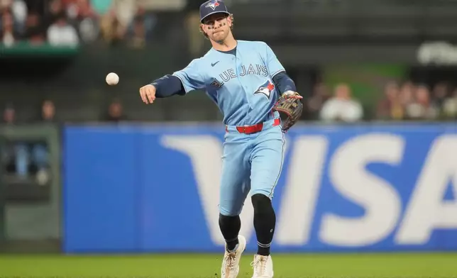 Toronto Blue Jays second baseman Ernie Clement throws out San Francisco Giants' Victor Bericoto at first base during the sixth inning of a baseball game Tuesday, July 7, 2026, in San Francisco. (AP Photo/Jeff Chiu)
