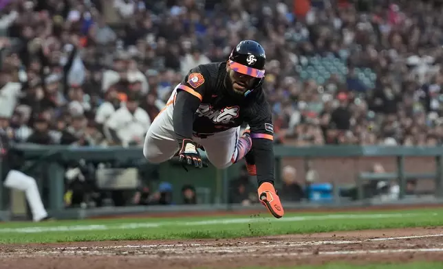 San Francisco Giants' Heliot Ramos slides home to score against the Toronto Blue Jays during the fifth inning of a baseball game Tuesday, July 7, 2026, in San Francisco. (AP Photo/Jeff Chiu)