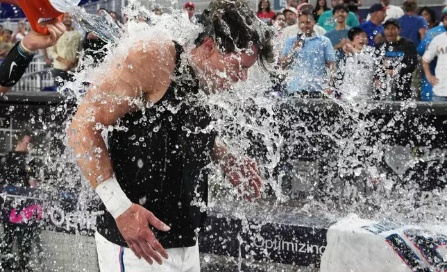 Miami Marlins' Griffin Conine, right, is doused after hitting a walk off single to defeat the Philadelphia Phillies in the the ninth inning of a baseball game, Monday, July 27, 2026, in Miami. (AP Photo/Lynne Sladky)