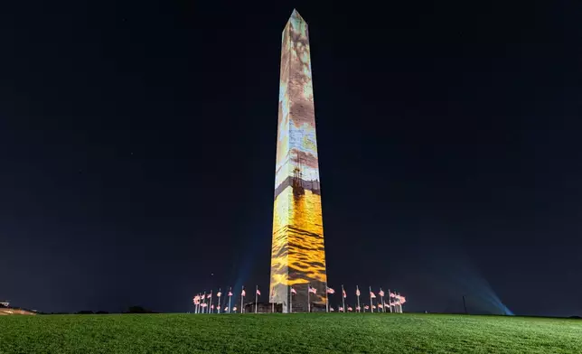 Images are projected onto the Washington Monument, Tuesday, June 30, 2026, in Washington. (AP Photo/Jen Golbeck)