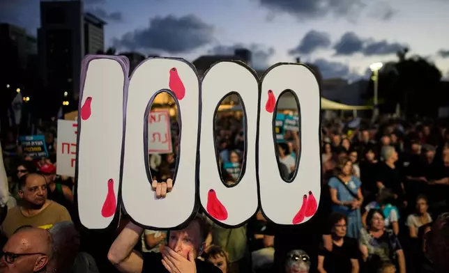 People participate in a rally marking 1,000 days to the deadly Oct. 7, 2023, Hamas-led attack on Israel, which sparked the war in Gaza, in Tel Aviv, Israel, Thursday, July 2, 2026. (AP Photo/Ohad Zwigenberg)