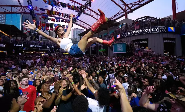 Fans celebrate during a watch party for a World Cup soccer match against Bosnia at the KC Live! entertainment district Wednesday, July 1, 2026, in Kansas City, Mo. (AP Photo/Charlie Riedel)