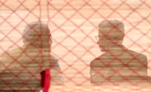 Indian Prime Minister Narendra Modi, left, and India’s foreign minister, Subrahmanyam Jaishankar, are seen behind a screen as they await the arrival of Japanese Prime Minister Sanae Takaichi for her ceremonial reception at the Presidential Palace in New Delhi, India, Thursday, July 2, 2026. (AP Photo/Manish Swarup)