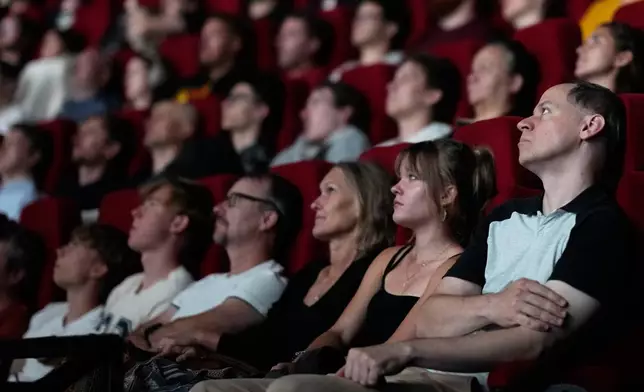 Spectators view the 70 mm Imax copy of Christopher Nolan's "The Odyssey" in Prague, Czech Republic, Monday, July 27, 2026. (AP Photo/Petr David Josek)