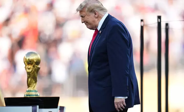 President Donald J. Trump walks onto the stage for the trophy presentation during the World Cup final soccer match between Spain and Argentina in East Rutherford, N.J., near New York, Sunday, July 19, 2026. (AP Photo/Abbie Parr)