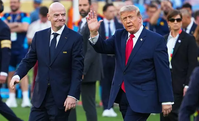President Donald J. Trump walks with FIFA President Gianni Infantino after the World Cup final soccer match between Spain and Argentina in East Rutherford, N.J., near New York, Sunday, July 19, 2026. (AP Photo/Julio Cortez)