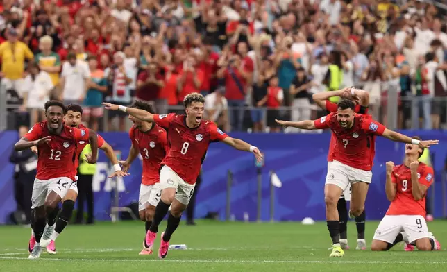 Egypts players celebrate after their teammate Hossam Abdelmaguid (4) score the winning penalty during World Cup round of 32 soccer match between Australia and Egypt in Arlington, Texas, near Dallas, Tuesday, Friday, July 3, 2026. (AP Photo/Sam Hodde)