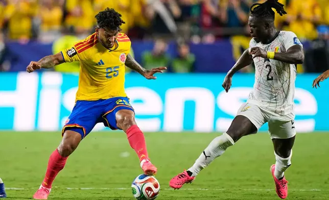 Colombia's Luis Suarez (25) and Ghana's Alidu Seidu (2) during the World Cup round of 32 soccer match between Colombia and Ghana in Kansas City, Mo., Friday, July 3, 2026. (AP Photo/Charlie Riedel)