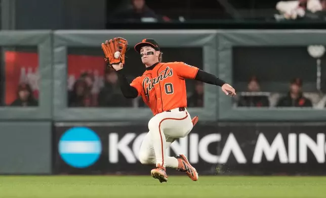 San Francisco Giants center fielder Drew Gilbert catches a fly out hit by Colorado Rockies' Mickey Moniak during the fifth inning of a baseball game, Friday, July 10, 2026, in San Francisco. (AP Photo/Jeff Chiu)