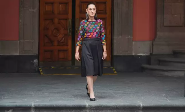Mexican President Claudia Sheinbaum arrives to welcome Switzerland's President Guy Parmelin and his wife Caroline Merotto at the National Palace in Mexico City, Wednesday, July 8, 2026. (AP Photo/Eduardo Verdugo)