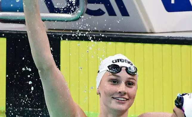 Summer McIntosh, left, reacts after setting a new world in the women's 200m butterfly final at the Canadian Swimming Trials in Montreal, on Sunday, July 5, 2026. (Graham Hughes/The Canadian Press via AP)