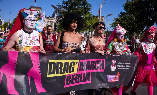 Sisters Pia, left, Sister Daphne, second right, and Sister Clementia, right, of the German chapter OSPI of the Sisters of Perpetual Indulgence, SPI, attend the first Berlin Drag March on the eve of the Pride March in Berlin, Germany, Friday, July 24, 2026. (AP Photo/Markus Schreiber)