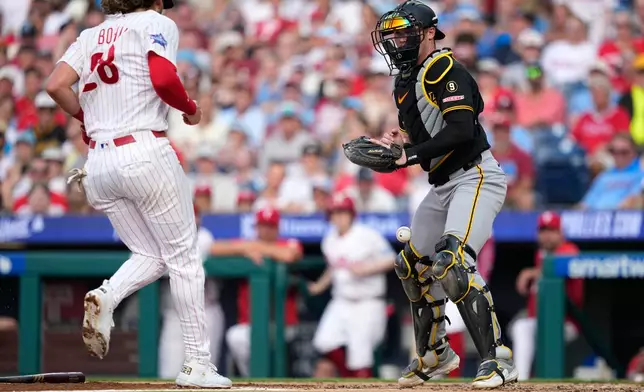Philadelphia Phillies' Alec Bohm, left, scores past Pittsburgh Pirates catcher Henry Davis on a two-run fielder's choice hit by Justin Crawford during the second inning of a baseball game Wednesday, July 1, 2026, in Philadelphia. (AP Photo/Matt Slocum)