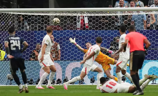 England goalkeeper Jordan Pickford (1) fails to stop a shot by Argentina's Enzo Fernandez (24) as he scores his side's first goal during the World Cup semifinal soccer match between England and Argentina in Atlanta, Wednesday, July 15, 2026. (AP Photo/Stephanie Scarbrough)