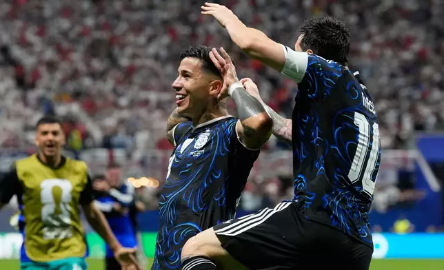 Argentina's Enzo Fernandez celebrates with Lionel Messi, right, after scoring his side's first goal during the World Cup semifinal soccer match between England and Argentina in Atlanta, Wednesday, July 15, 2026. (AP Photo/Rebecca Blackwell)