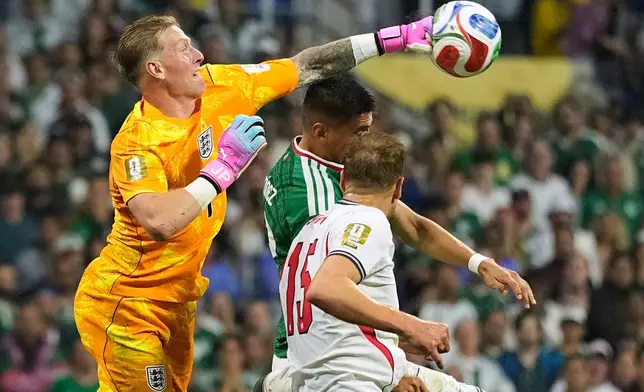 England goalkeeper Jordan Pickford (1) punches the ball clear of the goal during the World Cup round of 16 soccer match between Mexico and England in Mexico City, Sunday, July 5, 2026. (AP Photo/Natacha Pisarenko)