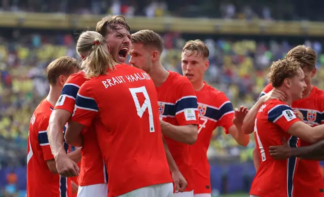 Norway's Erling Haaland (9) celebrates with teammates after scoring their first goal during the World Cup round of 16 soccer match between Brazil and Norway in East Rutherford, N.J., near New York, Sunday, July 5, 2026. (AP Photo/Pamela Smith)