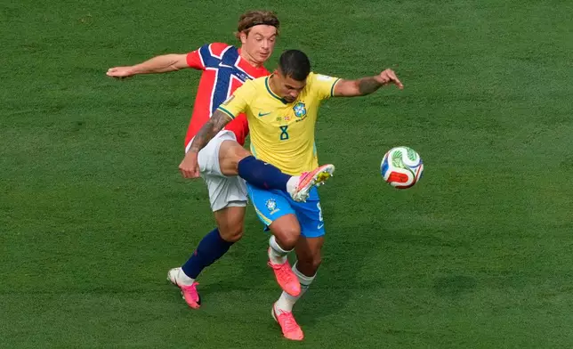 Norway's Patrick Berg (6) and Brazil's Bruno Guimaraes (8) during the World Cup round of 16 soccer match between Brazil and Norway in East Rutherford, N.J., near New York, Sunday, July 5, 2026. (AP Photo/Yuki Iwamura)