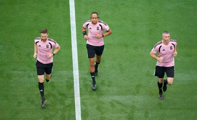 Referee Ismail Elfath, center, warms up for the World Cup round of 16 soccer match between Brazil and Norway in East Rutherford, N.J., near New York, Sunday, July 5, 2026. (AP Photo/Yuki Iwamura)
