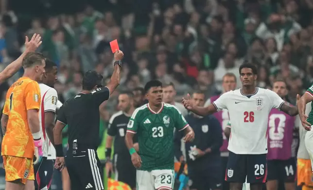 Referee Alireza Faghani, of Australia, a red card to England's Jarell Quansah, 26, during the World Cup round of 16 soccer match between Mexico and England in Mexico City, Sunday, July 5, 2026. (AP Photo/Silvia Izquierdo)