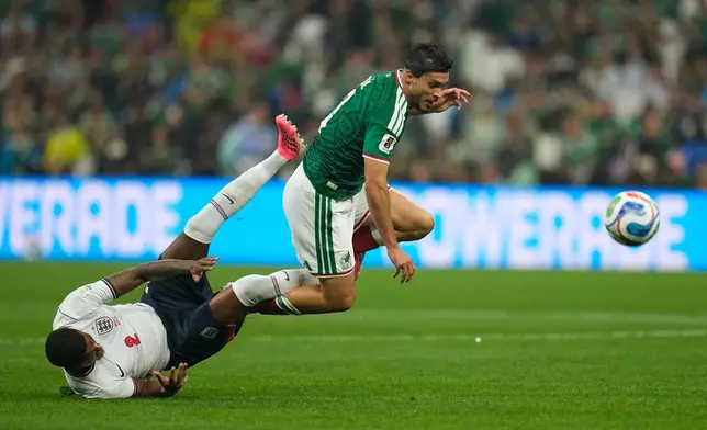 Mexico's Raul Jimenez, right, and England's Ezri Konsa collide while competing for the ball during the World Cup round of 16 soccer match between Mexico and England in Mexico City, Sunday, July 5, 2026. (AP Photo/Ricardo Mazalan)