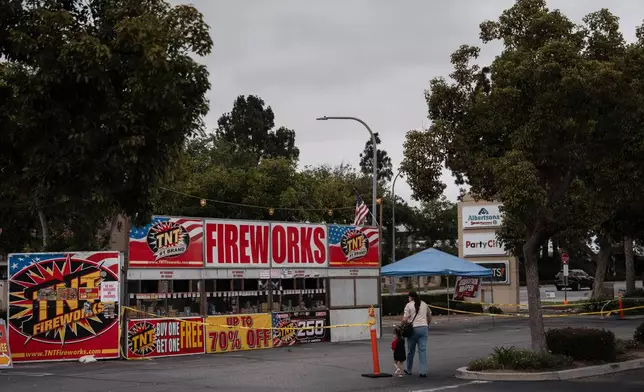 Samantha Ramirez and her daughter Asa walk to a TNT Fireworks stand in Alhambra, Calif., Tuesday, June 30, 2026, to purchase fireworks ahead of the Fourth of July holiday. (AP Photo/Jae C. Hong)