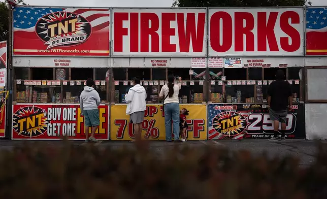People purchase fireworks at a TNT Fireworks stand in Alhambra, Calif., Tuesday, June 30, 2026, ahead of the Fourth of July holiday. (AP Photo/Jae C. Hong)