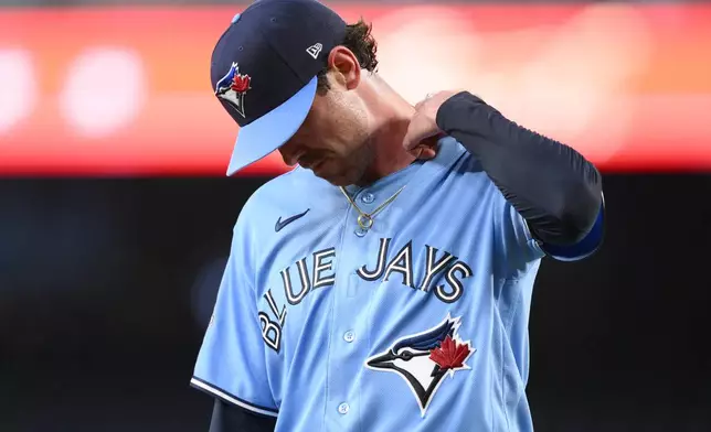 Toronto Blue Jays pitcher Shane Bieber walks back to the dugout after he was pulled from a baseball game in the first inning against the Washington Nationals, Tuesday, July 28, 2026, in Washington. (AP Photo/Nick Wass)