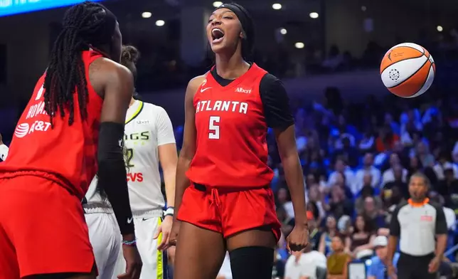 Atlanta Dream forward Angel Reese (5) reacts to scoring with teammate Rhyne Howard (10) during the second half of a WNBA basketball game against the Dallas Wings in Arlington, Texas, Wednesday, July 29, 2026. (AP Photo/LM Otero)