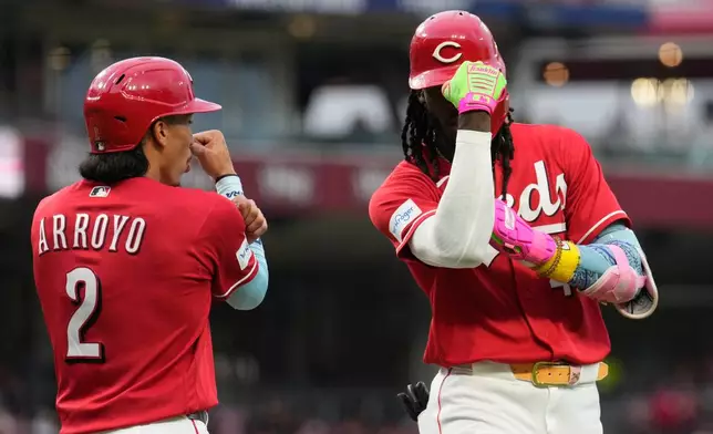 Cincinnati Reds' Elly de la Cruz, right, celebrates with Edwin Arroyo, left, after hitting a two-run homer during the fourth inning of a baseball game against the Philadelphia Phillies in Cincinnati, Wednesday, July 8, 2026. (AP Photo/Carolyn Kaster)