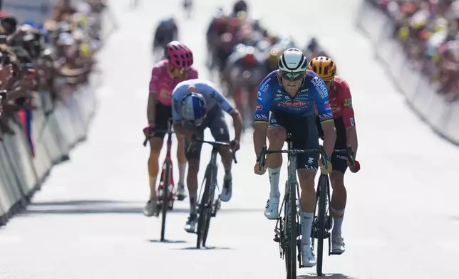Netherland's Mathieu van der Poel, center right, races to the finish line of the ninth stage of the Tour de France cycling race with start in Malemort and finish in Ussel, France, Sunday, July 12, 2026. (AP Photo/Thibault Camus)