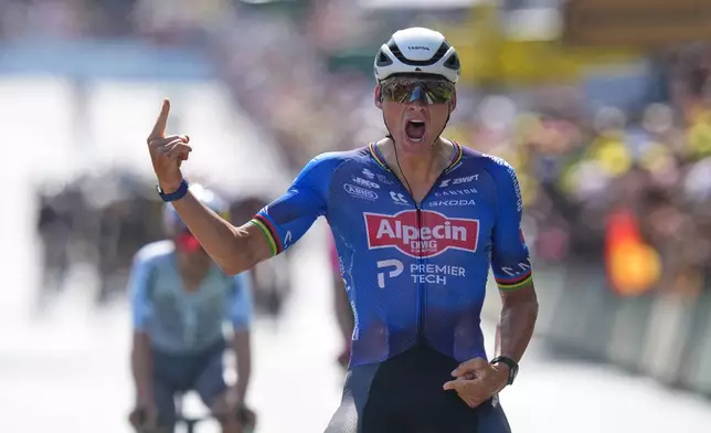 Netherland's Mathieu van der Poel celebrates as he crosses the finish line to win the ninth stage of the Tour de France cycling race with start in Malemort and finish in Ussel, France, Sunday, July 12, 2026. (AP Photo/Thibault Camus)