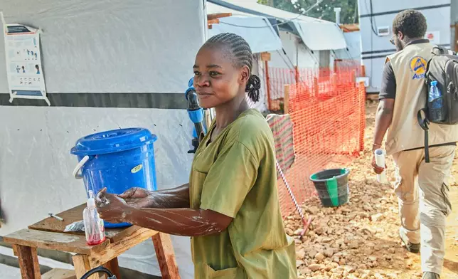 Health workers stand at the Evangelical Medical Center, in Bunia, eastern Congo, Friday, July 3, 2026, where Ebola clinical trials are scheduled to take place. (AP Photo/Dirole Lotsima Dieudonne)
