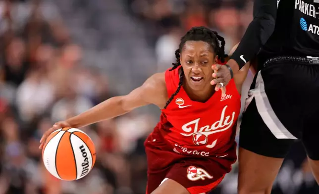 Indiana Fever guard Kelsey Mitchell (0) drives against Las Vegas Aces forward Cheyenne Parker-Tyus (32) during the first half of an WNBA basketball game Sunday, July 5, 2026, in Las Vegas. (Steve Marcus/Las Vegas Sun via AP)