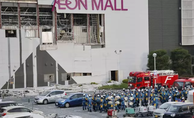 Police units gather in the parking lot before beginning operations at Aeon Mall Kumamoto in Kashima, Kumamoto Prefecture, Friday, July 31, 2026. (Kyodo News via AP)