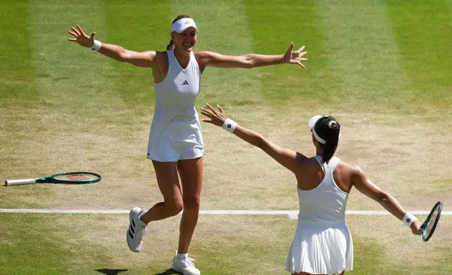 Guo Hanyu of China and Kristina Mladenovic of France, left, react after winning against Luisa Stefani of Brazil and Gabriela Dabrowski of Canada in the women's doubles final at Wimbledon Tennis Championships in London, Sunday, July 12, 2026. (AP Photo/Kirsty Wigglesworth)