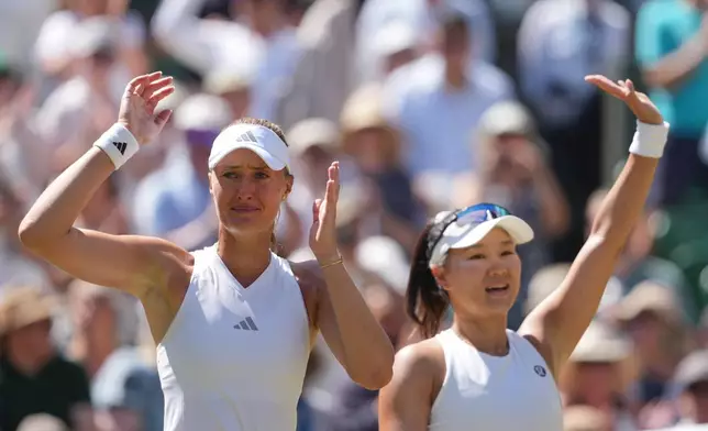 Kristina Mladenovic of France, left playing partner Hanyo Guo of China, celebrate after defeating with Luisa Stefani of Brazil and Gabriela Dabrowski of Canada, in the women's doubles final, playing against at Wimbledon Tennis Championships in London, Sunday, July 12, 2026. (AP Photo/Kin Cheung)