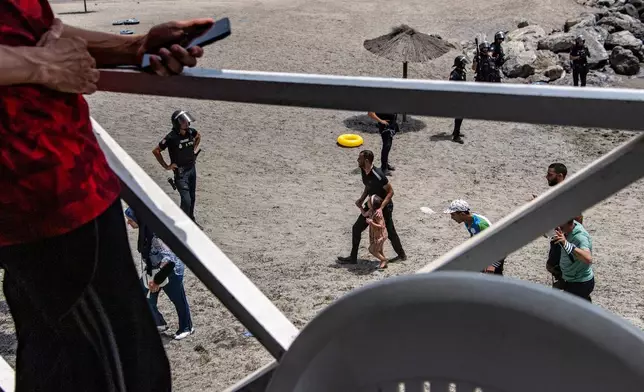 Migrants arrive after crossing from Morocco into the Spanish enclave of Ceuta, Thursday, July 30, 2026. (AP Photo/Antonio Sempere)