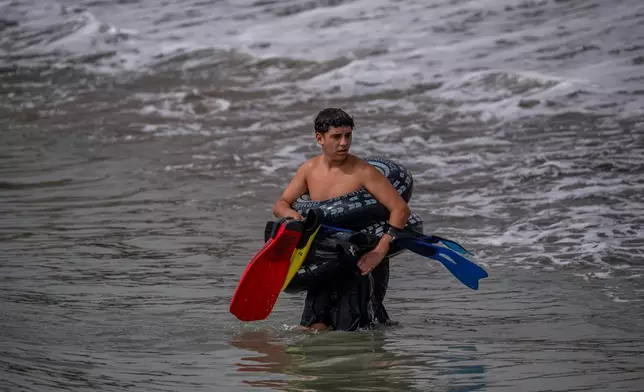 A migrant crosses from Morocco into the Spanish enclave of Ceuta, Thursday, July 30, 2026. (AP Photo/Antonio Sempere)