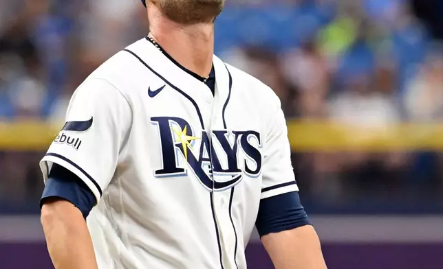 Tampa Bay Rays pitcher Shane McClanahan reacts after giving up a walk during the fourth inning of a baseball game against the Texas Rangers Thursday, July 30, 2026, in St. Petersburg, Fla. (AP Photo/Jason Behnken)