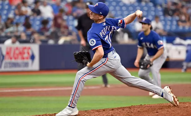 Texas Rangers pitcher Ben Peoples throws during the eighth inning of a baseball game against the Tampa Bay Rays, Thursday, July 30, 2026, in St. Petersburg, Fla. (AP Photo/Jason Behnken)