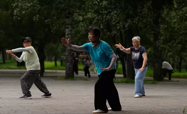 Women practice Tai Chi at a park near the Temple of Heaven in Beijing, Thursday July 9, 2026. (AP Photo/Andy Wong)