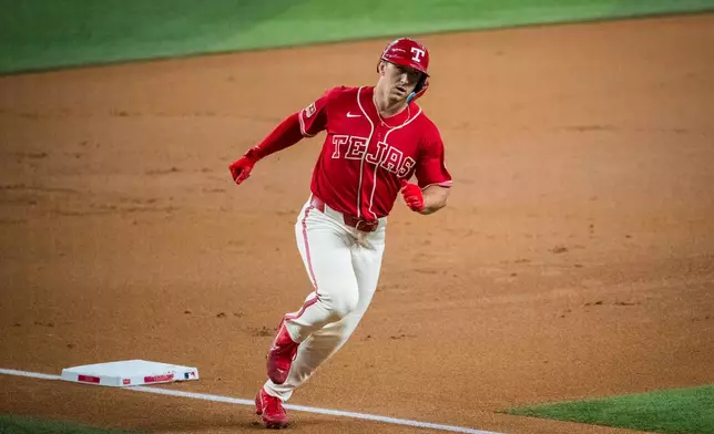 Texas Rangers' Wyatt Langford rounds the bases after hitting a home run during the first inning of a baseball game against the Seattle Mariners, Friday, July 24, 2026, Arlington, Texas. (AP Photo/Jessica Tobias)