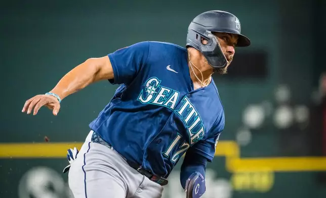 Seattle Mariners' Josh Naylor runs towards home during the second inning of a baseball game against the Texas Rangers, Friday, July 24, 2026, Arlington, Texas. (AP Photo/Jessica Tobias)