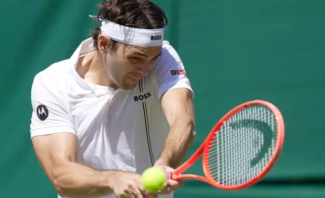 Taylor Fritz of the United States returns the ball to Patrick Kypson of the United States in their second round men's singles match at the Wimbledon Tennis Championships in London, Thursday, July 2, 2026. (AP Photo/Brian Inganga)