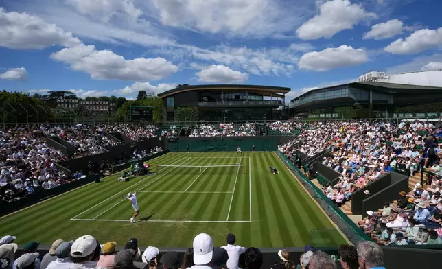 Tennis supporters watch the men's singles match Alex de Minaur of Australia against Roman Andres Burruchaga of Argentina at the Wimbledon Tennis Championships in London, Tuesday, June 30, 2026.(AP Photo/Kin Cheung)