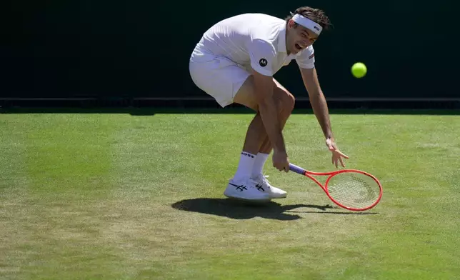 Taylor Fritz of the United States returns the ball to Patrick Kypson of the United States in their second round men's singles match at the Wimbledon Tennis Championships in London, Thursday, July 2, 2026. (AP Photo/Brian Inganga)