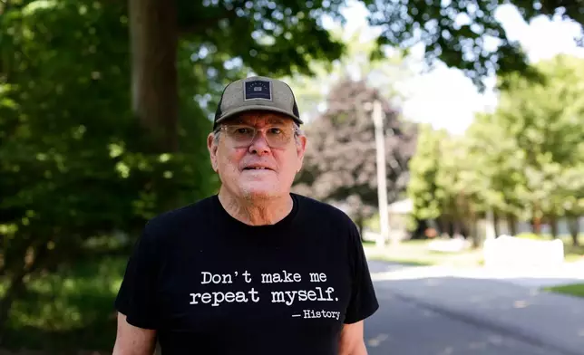 Dave Burdick, a supporter of Democratic Senate candidate Abdul El-Sayed, stands for a portrait outside of his home in Douglas, Mich., on Tuesday, July 7, 2026. (AP Photo/Kristen Norman)