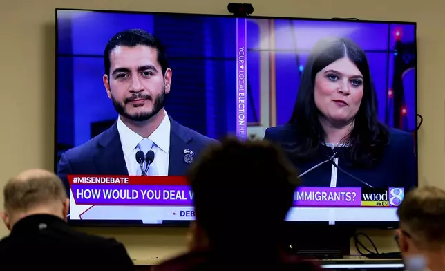Michigan U.S. Senate candidates, Abdul El-Sayed, left, and Rep. Haley Stevens, D-Mich., are displayed on a television during a debate inside the spin room at WoodTV studios on Tuesday, July 7, 2026, in Grand Rapids, Mich. (AP Photo/Kristen Norman)