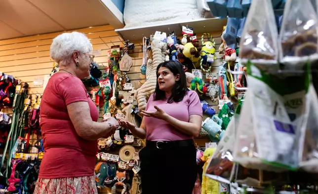 Rep. Haley Stevens, D-Mich., shops at the Decadent Dogs pet store with owner, Roxanne Leder, in South Haven, Mich., on Tuesday, July 7, 2026. (AP Photo/Kristen Norman)